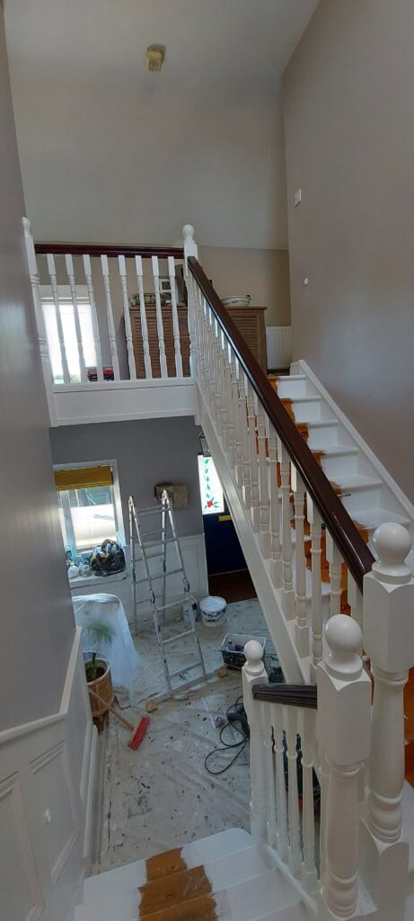 Hallway staircase during home renovation with ladder