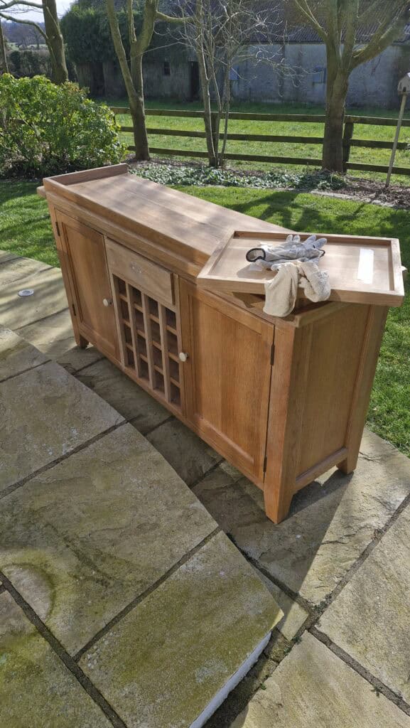 Wooden sideboard cabinet on sunny garden patio