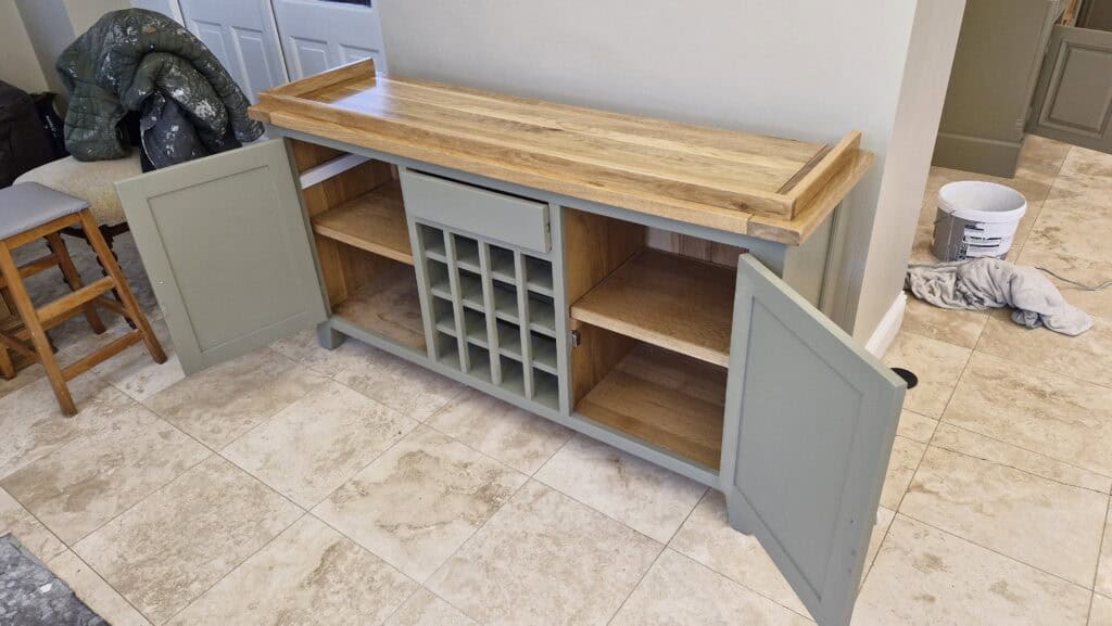 Kitchen island with wooden top and open cupboards