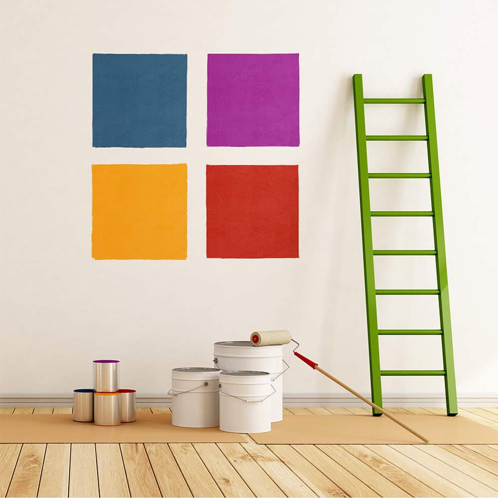 Paint samples on wall with ladder and tins
