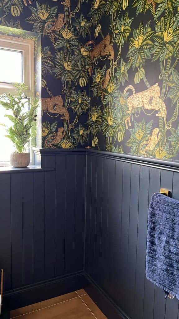 Jungle leopard wallpaper in navy bathroom interior
